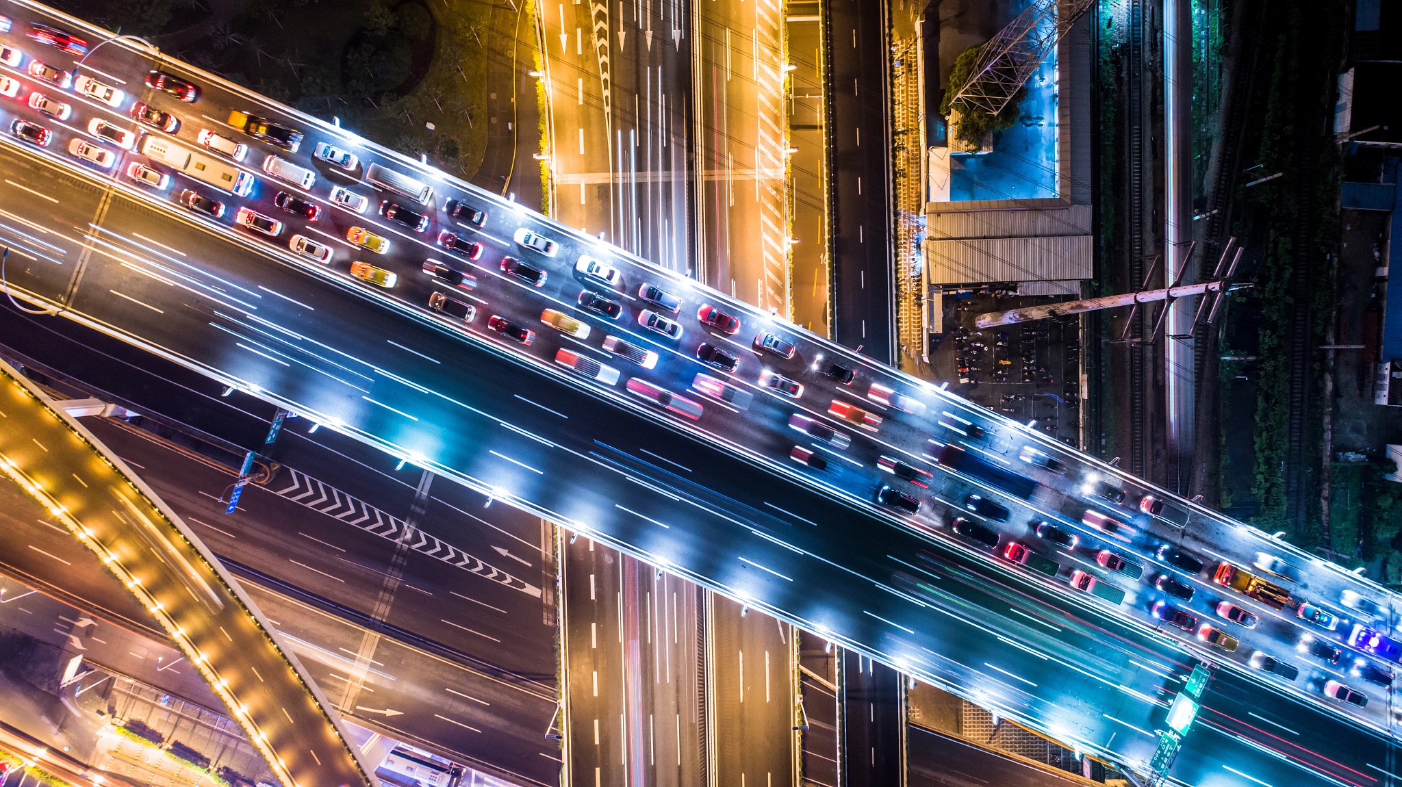 cars in traffic across a bridge at night